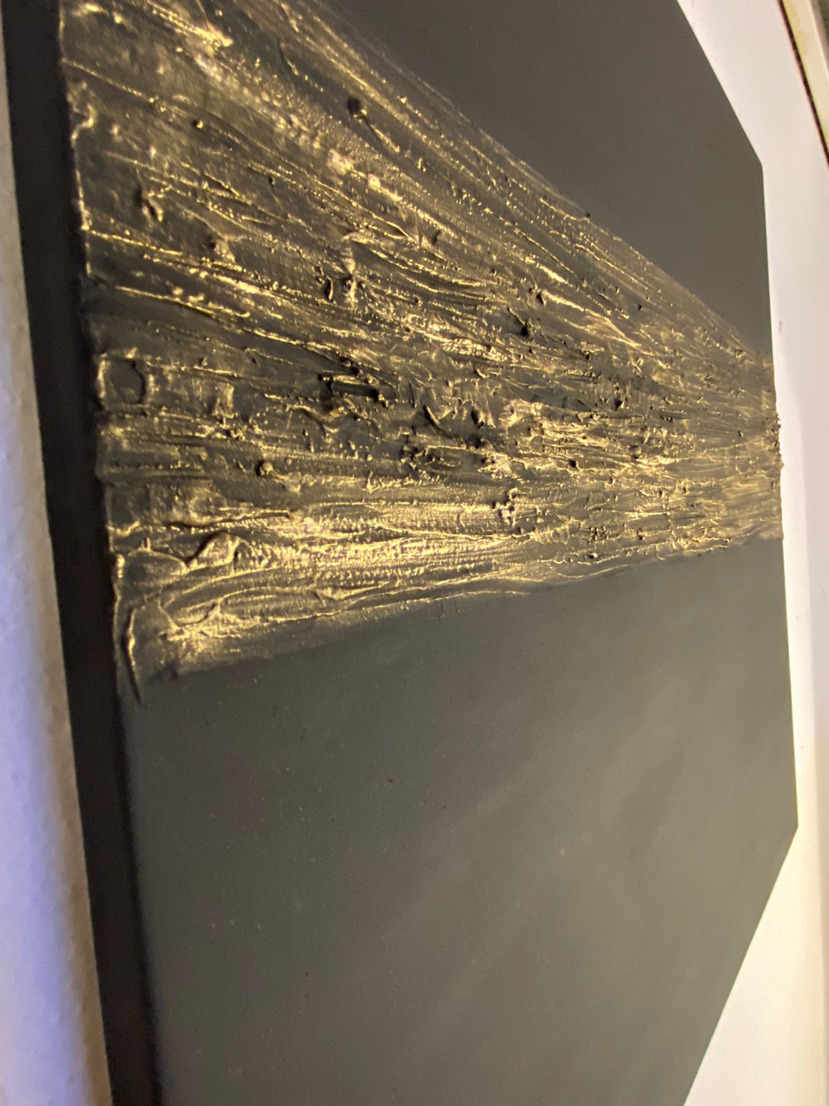 Close-up of a textured black surface with gold accents